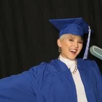 student poses using foam finger